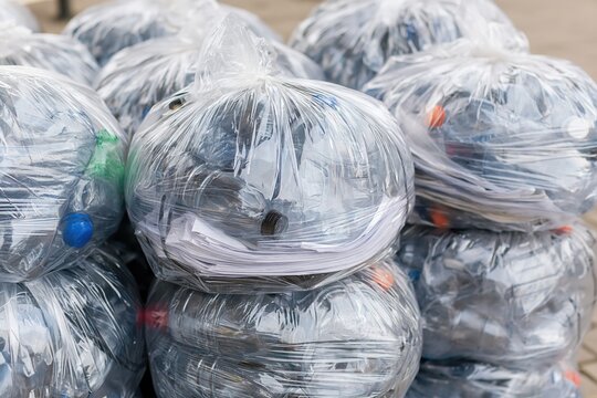 Large Stack of Clear Plastic Bags Filled with Recyclable Materials and Paper for Collection