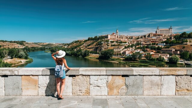 Woman looking at the historic city of toledo