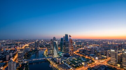 Fototapeta premium Panoramic Aerial View of Illuminated Cityscape Illustrating Urban Growth and Economic Progress at Dusk.