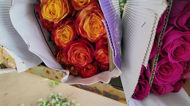 close up of packed colorful rose bouquets in a greenhouse