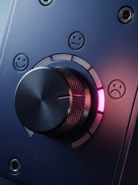Metal control dial glowing pink near lowest setting on control panel