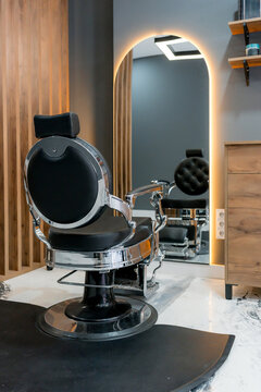 Modern barbershop interior with classic barber chair and mirror