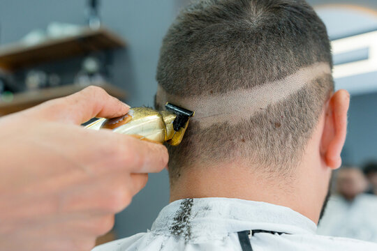 Barber create precise fade haircut with electric clipper