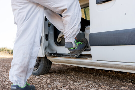 Beekeeper step out of van in protective workwear