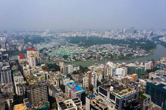 Aerial view of the Gulshan 2 area in Dhaka, featuring a dense urban skyline with high-rise buildings, a winding river, and lush greenery in Dhaka, Dhaka Division, Bangladesh.