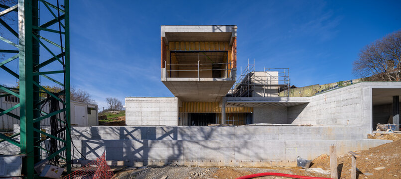 Modern concrete house construction site under blue sky