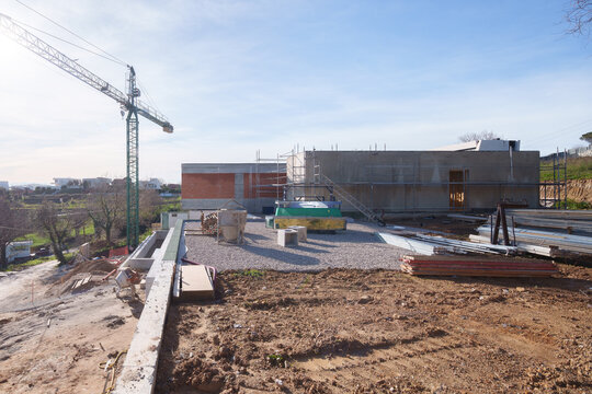 House construction site with crane and unfinished structure