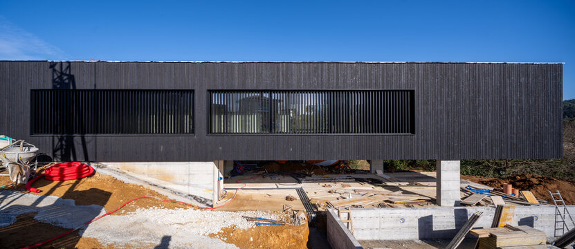 Contemporary black cantilevered house under construction in Santander