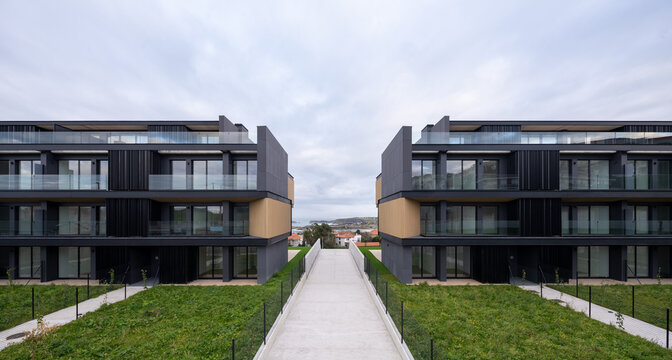 Modern hillside residential apartment complex with central walkway