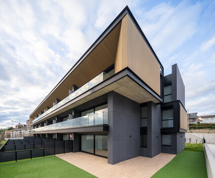 Modern hillside residential apartment building with glass balconies