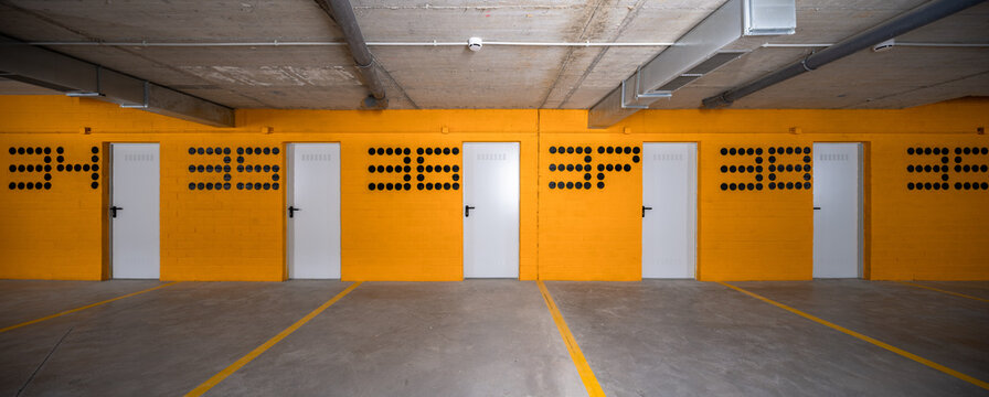 Modern hillside residential parking garage with orange wall