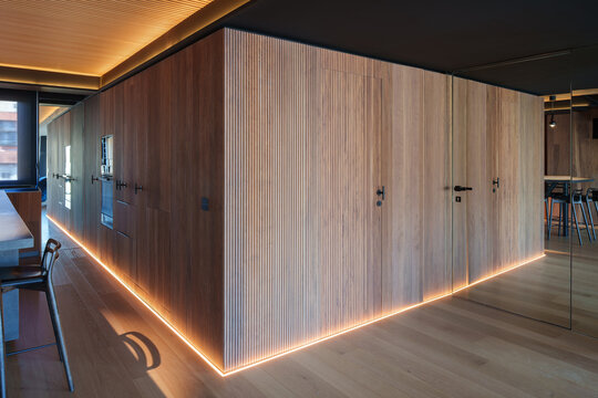 Modern coastal wooden interior with illuminated partition wall