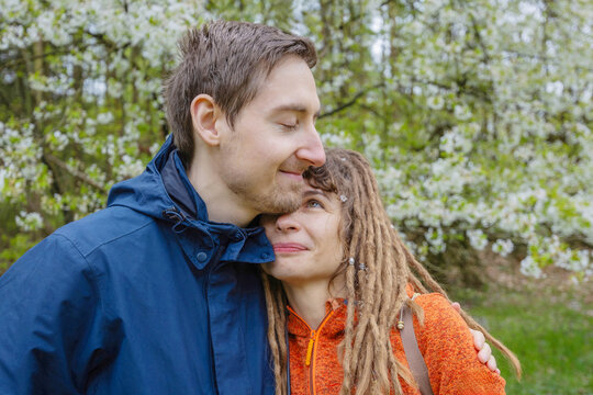 Loving couple embrace in a green park