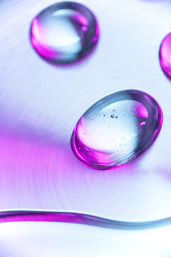 Abstract liquid droplet with pink and blue tech background