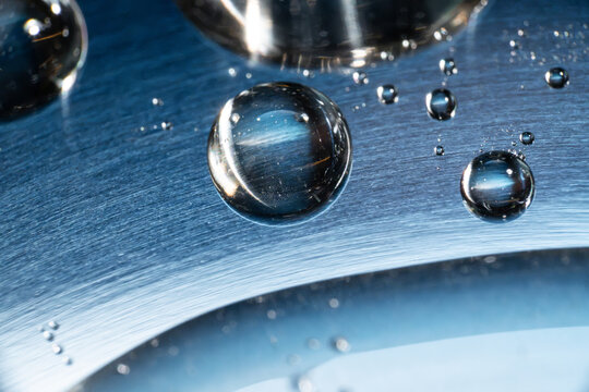 Water droplet on brushed metal tech background