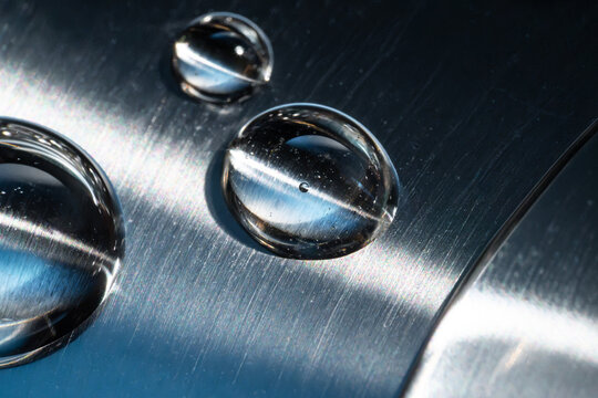 Water droplet on brushed metal technology background