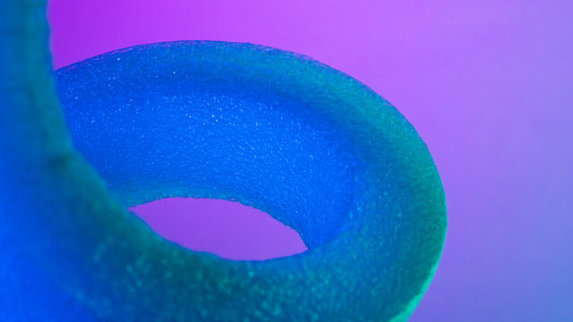 Abstract blue and green foam loop on purple background