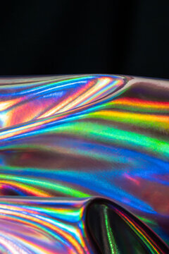 Holographic metal texture with vibrant rainbow reflections