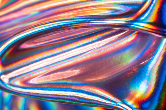 Iridescent holographic metal surface with colorful reflections