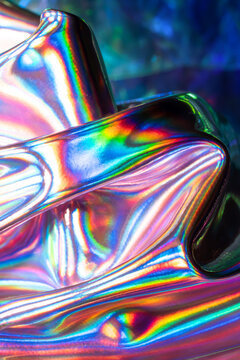 Iridescent holographic metal surface with rainbow reflections