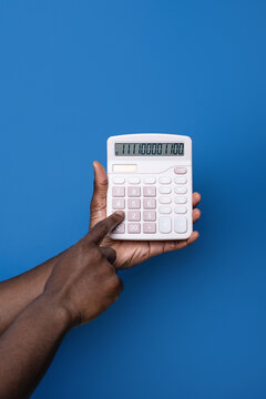 Black man use calculator against blue background