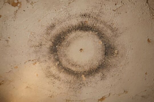 Atmospheric candle ring on aged plaster backdrop  
An atmospheric candle ring on an aged plaster backdrop that conveys quiet reverence and timeworn character