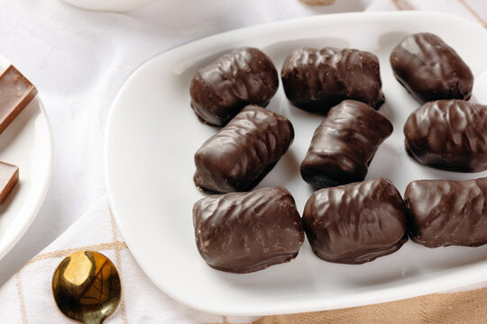 Dark chocolate sweets beside a cup of herbal tea
