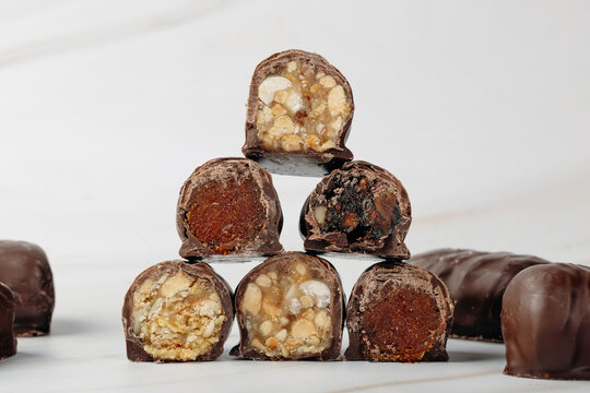 Chocolate covered nut confection with caramel filling
