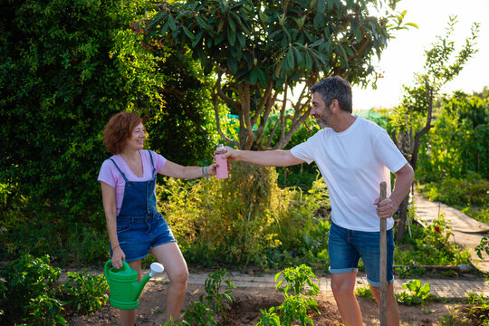 Farmers refreshing drinks while gardening outdoors