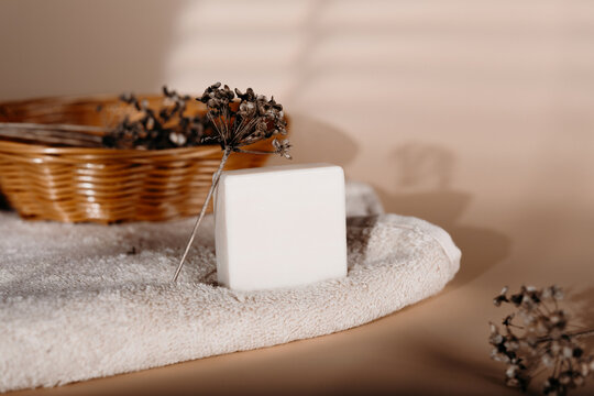 Natural soap bar on towel with dried flower and basket