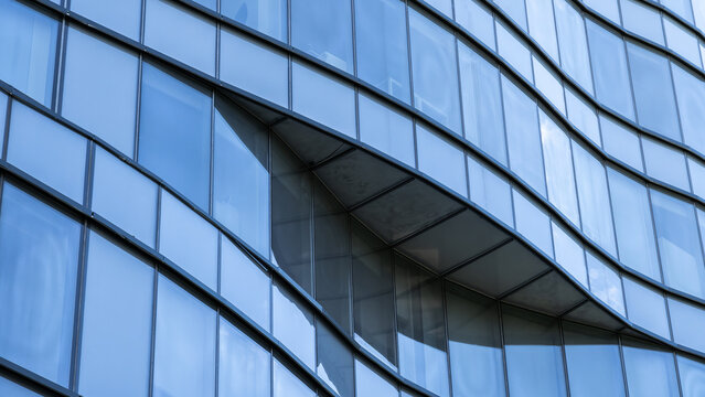 Curved geometric facade of contemporary glass office building