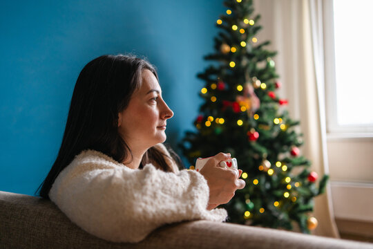 Woman enjoy Christmas at home with festive tree