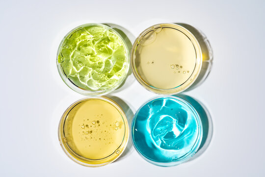 Colorful cosmetic gel samples in Petri dishes