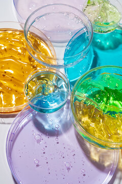 Colorful cosmetic gel samples in Petri dish laboratory