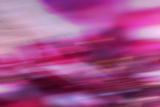 Abstract blurred colorful motion background in pink and purple