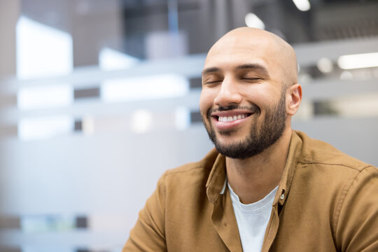 Mindfulness and mental health, smiling man practicing meditation and stress relief in office environment, Employee finding calm and balance during workday, professional wellness and positive mindset