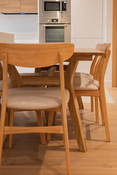 Modern apartment dining area with wooden table and chairs