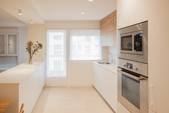 Modern apartment kitchen with built-in oven and island