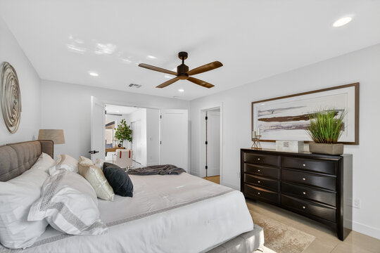 Spacious modern bedroom with king bed and dresser