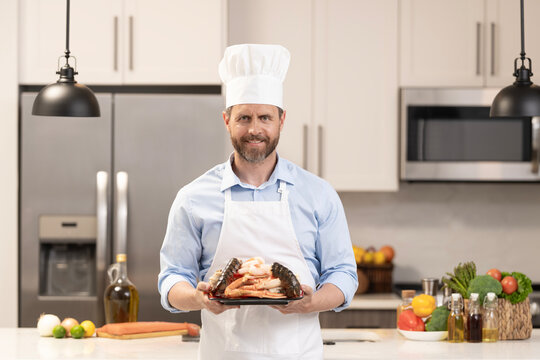 Hispanic man preparing seafood in barbecue. Chef barbecuing seafood. Backyard BBQ. Man cook seafood. Man with barbeque roast seafood. Grilling and barbecue. BBQ and grill. Backyard barbecue