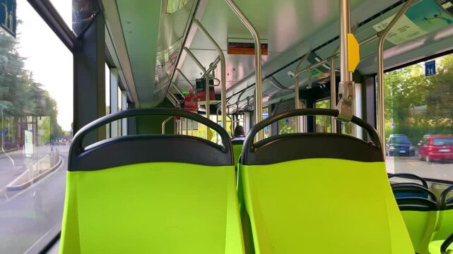 Interior of an electric city bus while traveling through Milan, Italy, combining public transit, electric mobility and sustainable urban transportation in a single moving scene.