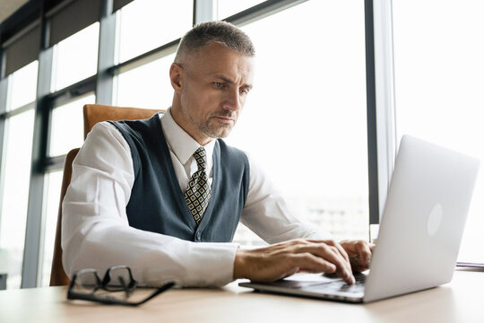 Remote online working. Executive office. Businessman using laptop in business office. Freelancer working online with data. Man CEO negotiating online. Businessman in suit with laptop in office