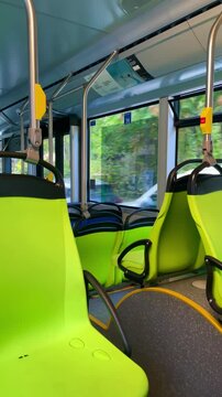 Electric bus traveling through Milan, Italy, with an empty passenger compartment, highlighting the role of electric vehicles in cleaner urban transportation and sustainable mobility.
