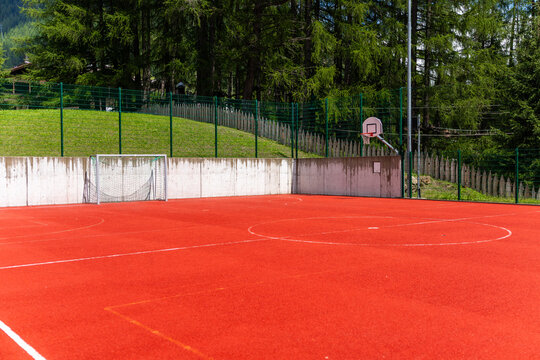 Empty outdoor sports court with football goal and hoop