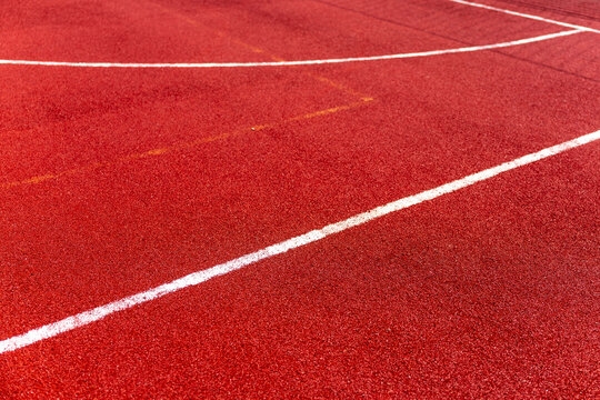 Red football stadium pitch with white field markings