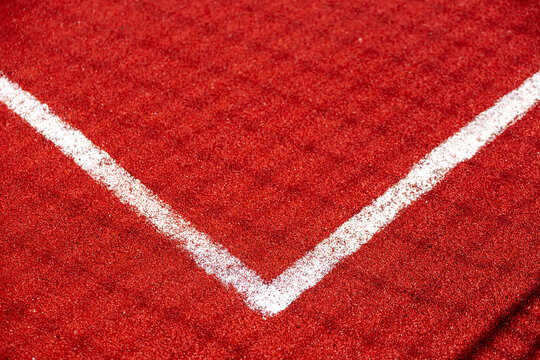 White field line on red football stadium surface