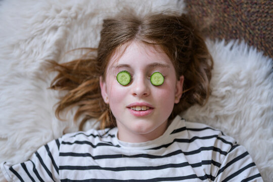 Girl relax with cucumber eye mask at home