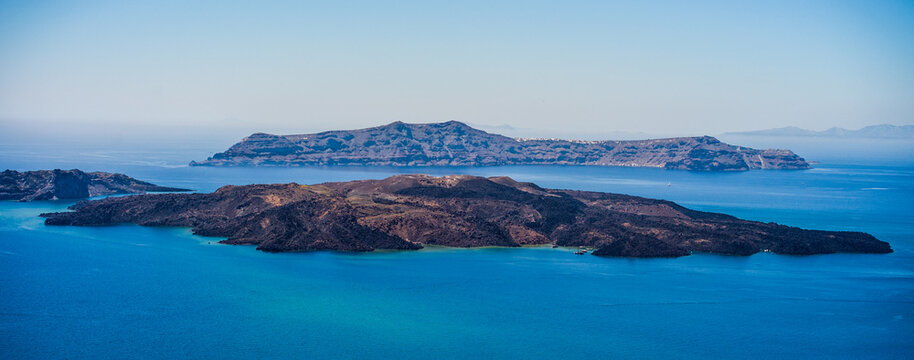 Santorini volcanic caldera islands surrounded by blue sea