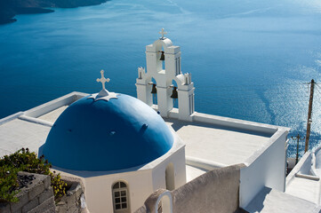 Blue domed chapel overlooking the Aegean Sea in Santorini © GreeceYou