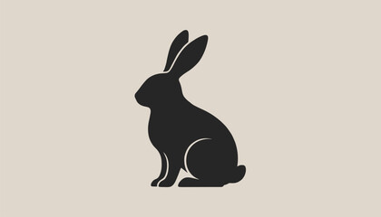 Obraz premium Classic silhouette of a sitting rabbit facing left, presented in solid black against a light cream-beige background.